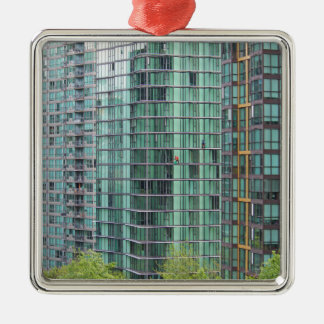 Window washers on downtown high rise building metal tree decoration