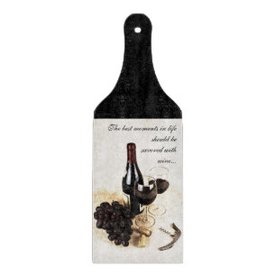 Wine bottle, wine glasses and grapes cutting board