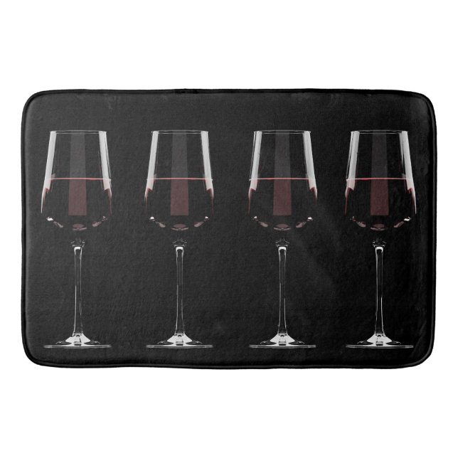Wine glasses with red wine on black bath mat (Front)