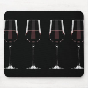 Wine glasses with red wine on black mouse mat