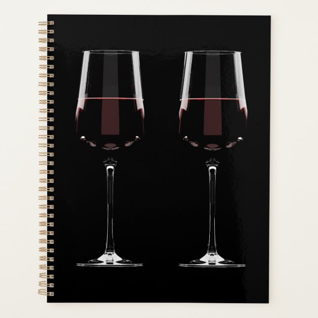 Wine glasses with red wine on black planner (Front)