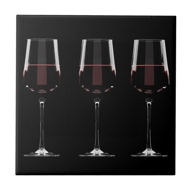 Wine glasses with red wine on black tile (Front)