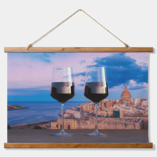 Wine glasses with view of sunset over Valletta Hanging Tapestry