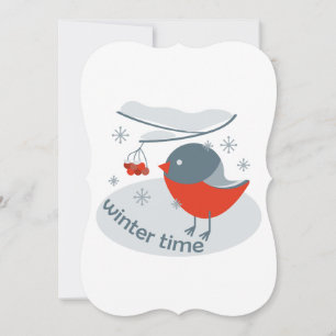Winter bullfinch bird and red rowan berries