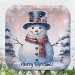 Winter Forest Snowman Christmas | Pink Paper Plate<br><div class="desc">Bring the charm of a winter forest to your holiday gatherings and Christmas parties with this Pink Winter Forest Snowman Paper Plates. These sturdy plates feature a delightful smiling snowman surrounded by snowy pine trees and white snowflakes, with falling snow adding a festive touch. The festive script displaying "Merry Christmas"...</div>