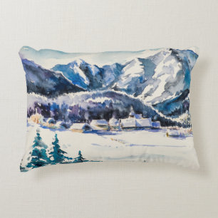 Winter landscape with mountain village covered wit decorative cushion