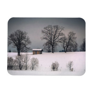 Winter scene, hill and trees, hut magnet