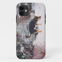 Winter snow scene with cute black and tan dog