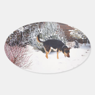 Winter snow scene with cute black and tan dog oval sticker