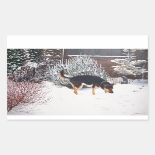 Winter snow scene with cute black and tan dog rectangular sticker