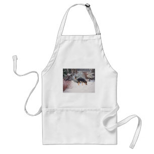 Winter snow scene with cute black and tan dog standard apron