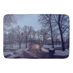Winter snowy city park in the evening bath mat