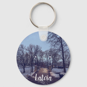 Winter snowy city park in the evening key ring