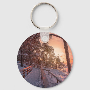 Winter sunset in pine forest near sea key ring