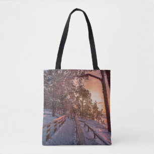 Winter sunset in pine forest near sea tote bag