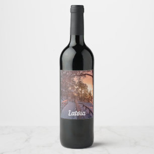 Winter sunset in pine forest near sea wine label