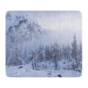Winter wonderland, fog, spruce forest and mountain cutting board
