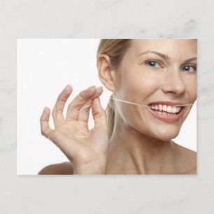 Woman against white background flossing teeth, postcard