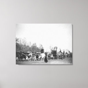 Woman and Boy with Bullwhackers in Ox Train Canvas Print