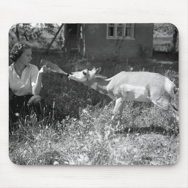 Woman bottle feeding an antelope. mouse mat (Front)