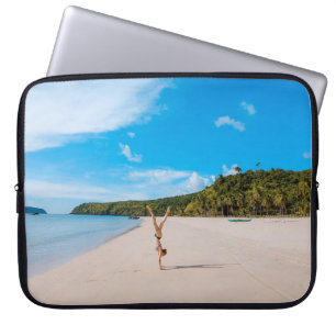 Woman doing acrobatic on seashore near mountain ra laptop sleeve