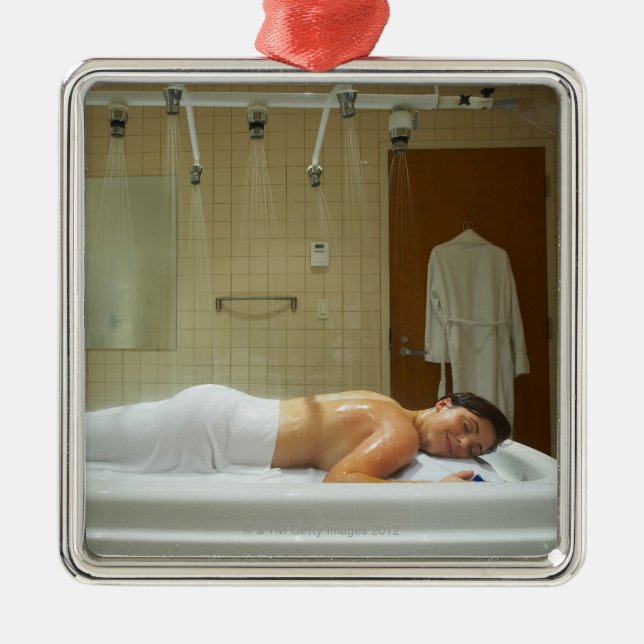 Woman enjoying hydrotherapy in vichy shower metal tree decoration (Front)