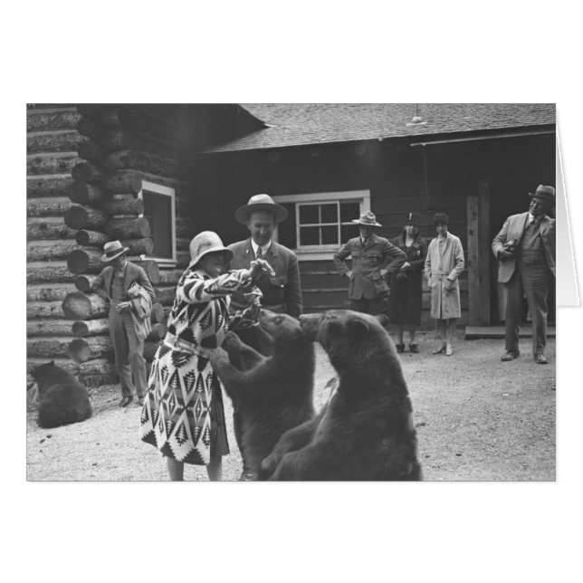 Woman feeding bears with a group of people in fron (Front Horizontal)