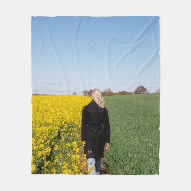 Woman in black coat standing on green grass field  fleece blanket (Front)