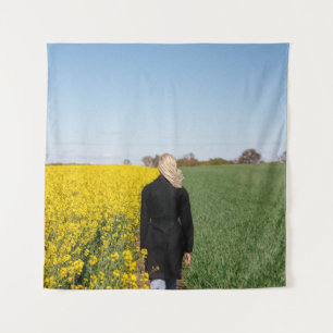 Woman in black coat standing on green grass field  tapestry