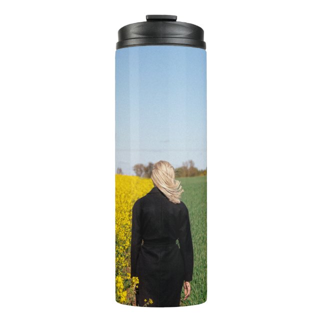 Woman in black coat standing on green grass field  thermal tumbler (Front)