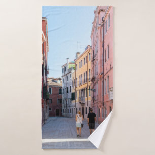 Woman in black jacket walking on sidewalk in the m bath towel