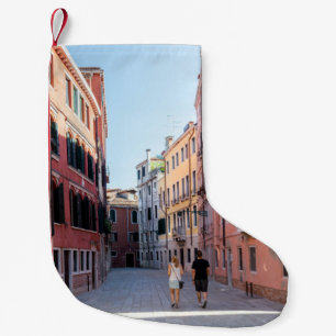 Woman in black jacket walking on sidewalk in the m small christmas stocking
