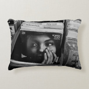WOMAN IN BLACK SHIRT IN FRONT OF BOOKS DECORATIVE CUSHION