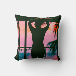 WOMAN IN BLACK TANK TOP AND PANTS STANDING ON BLAC CUSHION