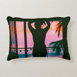 Woman in black tank top and pants standing on blac decorative cushion