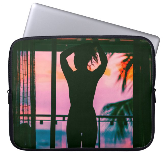Woman in black tank top and pants standing on blac laptop sleeve (Front)