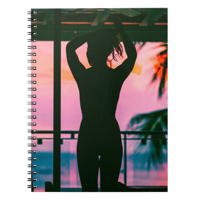 Woman in black tank top and pants standing on blac notebook (Front)