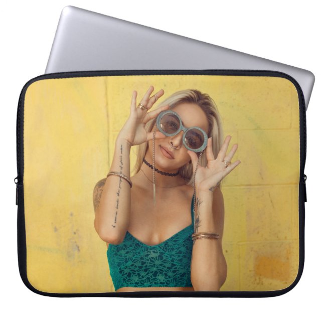 Woman in blue bralette holding sunglasses putting  laptop sleeve (Front)