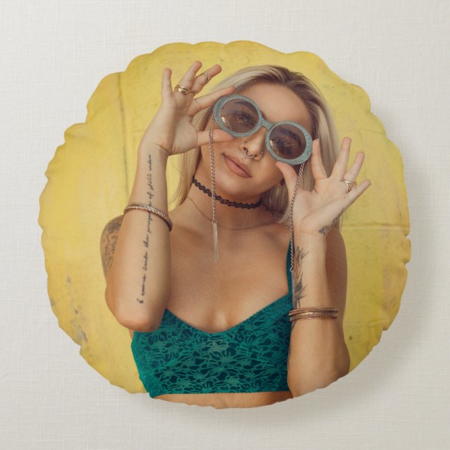 Woman in blue bralette holding sunglasses putting  round cushion (Front)