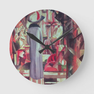 Woman in front of a large illuminated window round clock