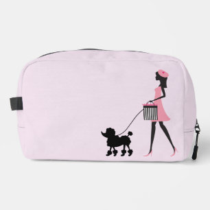Woman in pink walking black poodle  dopp kit