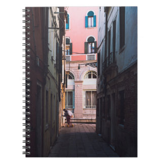 WOMAN IN WHITE SHIRT AND BLACK PANTS WALKING ON SI NOTEBOOK