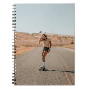 Woman in white shirt running on road in the mornin notebook