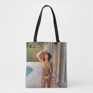 Woman in yellow bikini standing on brown brick flo tote bag