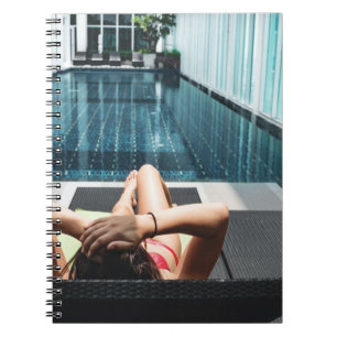 Woman laying on brown chaise lounge notebook