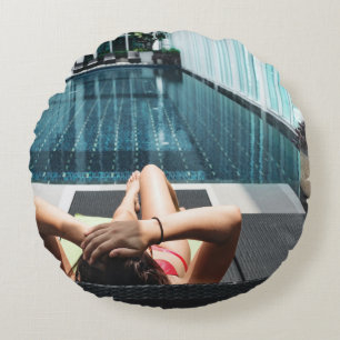 Woman laying on brown chaise lounge round cushion