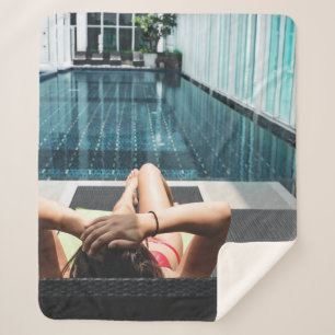 Woman laying on brown chaise lounge sherpa blanket