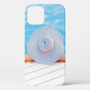 Woman leaning on white concrete surface beside swi iPhone 12 case