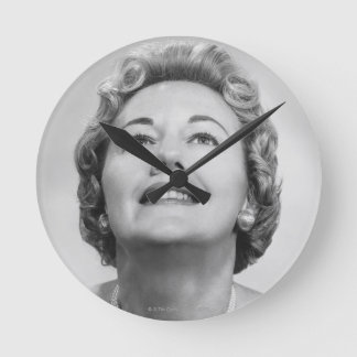 Woman Looking Up Round Clock