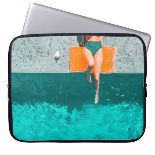 Woman lying beside swimming pool in the morning laptop sleeve